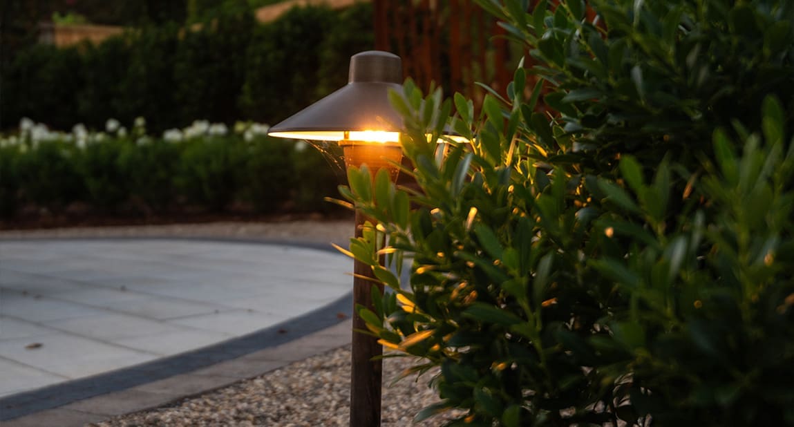 A beautiful backyard landscaping project at dusk with perfect lighting, designed and built by R&R Landscaping.