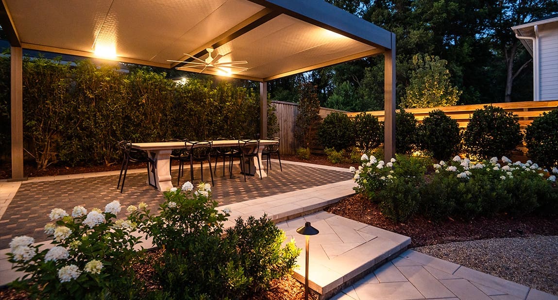 A beautiful backyard landscaping project at dusk with perfect lighting, designed and built by R&R Landscaping.
