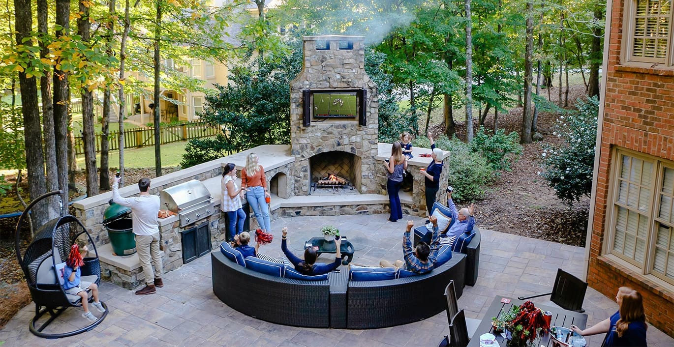 A beautiful outdoor kitchen and sitting area perfect for tailgating at home. This project was designed and built by R&R Landscaping